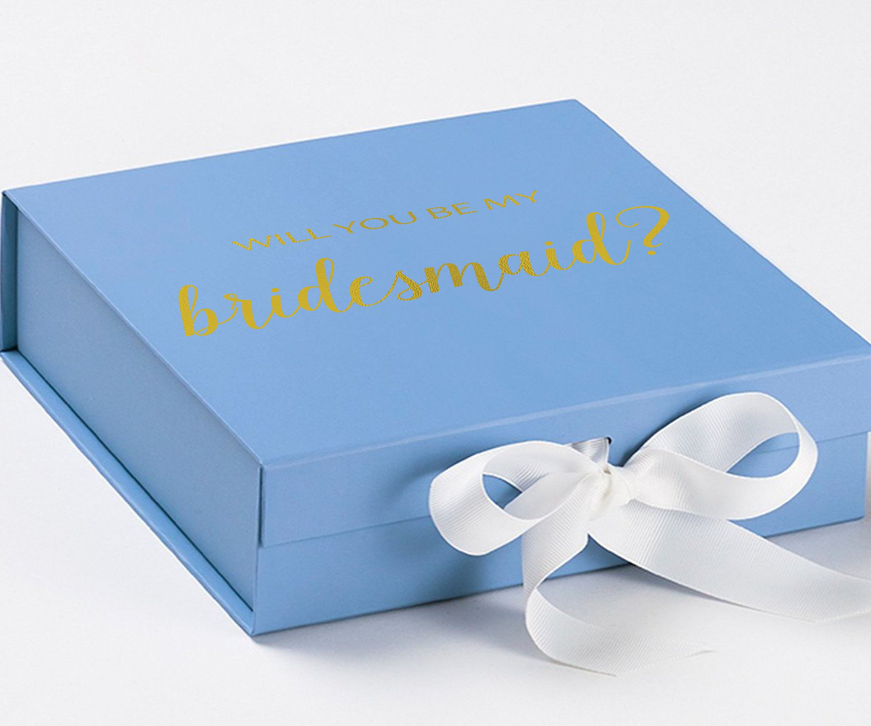 Light blue bridesmaid proposal box with white bow and metallic writing on the lid, showcasing its elegant design.