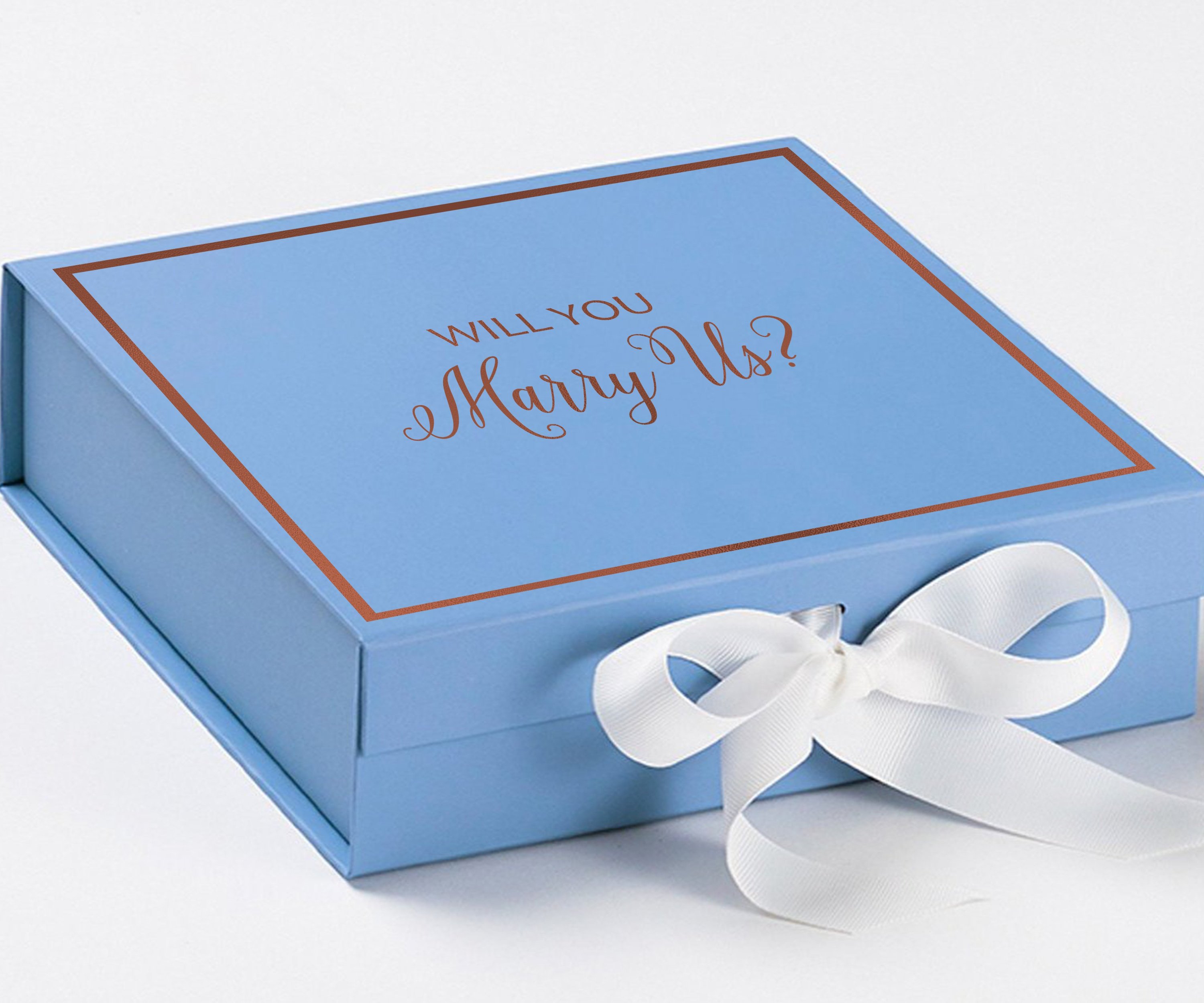 Light blue proposal box with white bow and metallic writing, perfect for engagement gifts.
