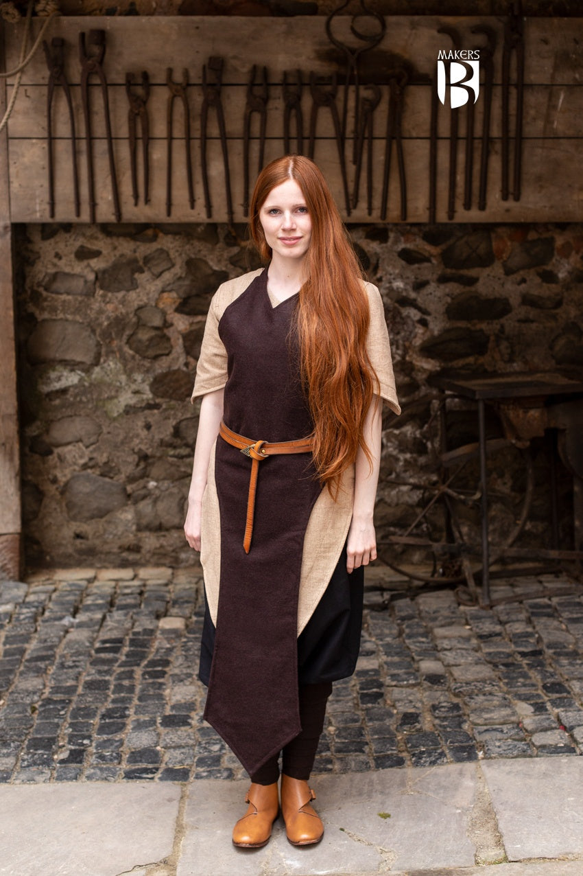 Asua Brown Apron featuring a long, straightforward design, perfect for layering and enhancing silhouette.