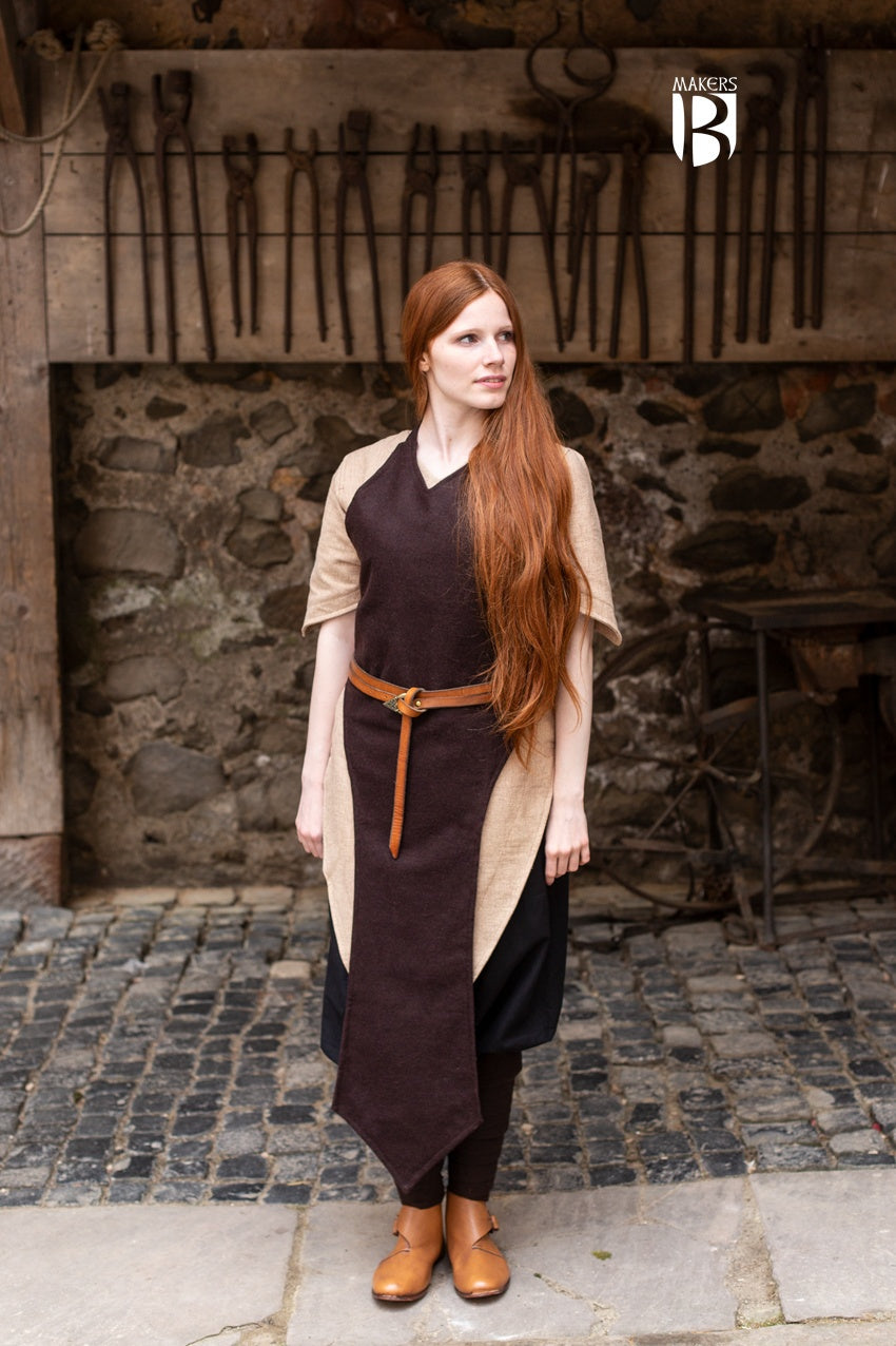 Asua Brown Apron featuring a long, straightforward design, perfect for layering and enhancing silhouette.