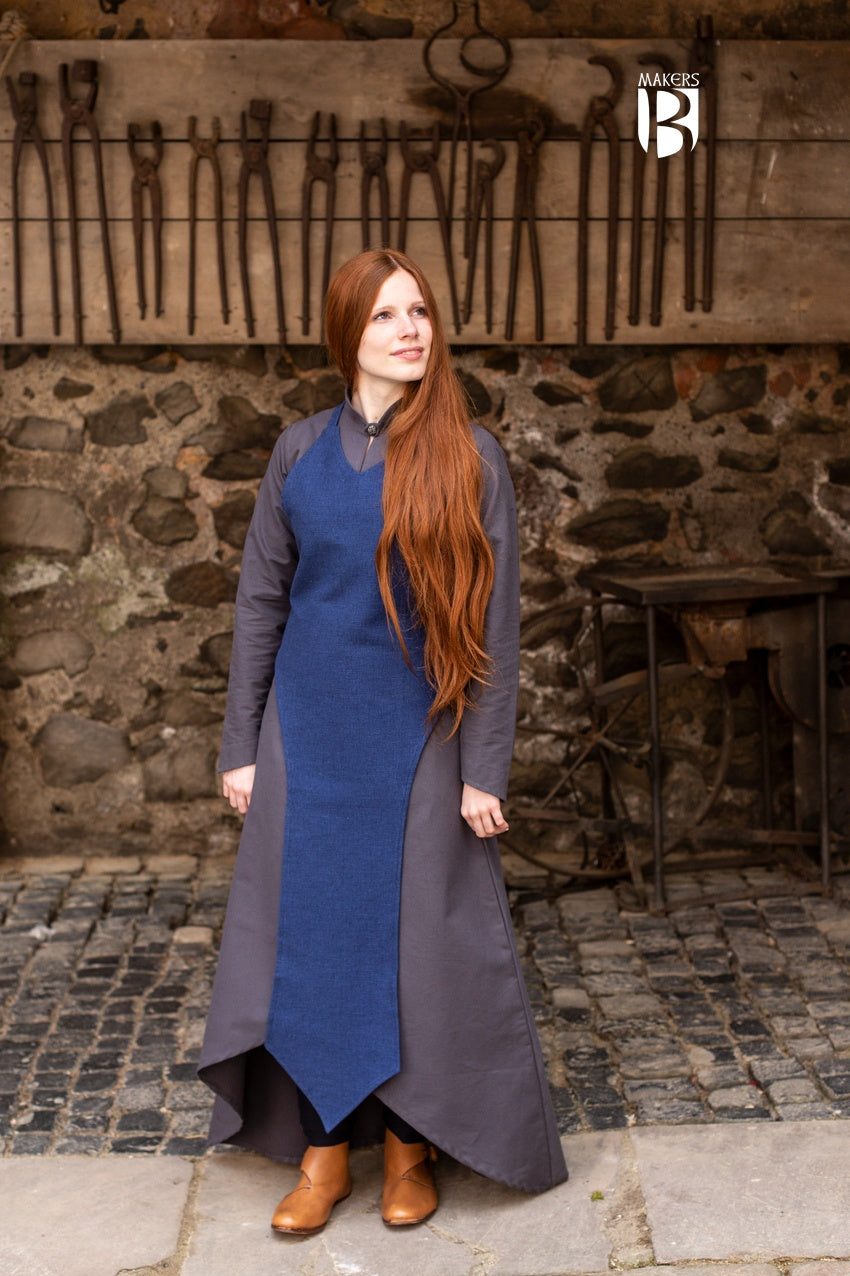 Stylish Isa Blue Apron featuring a long, straightforward design, perfect for layering and enhancing silhouette.