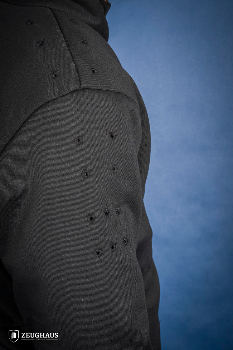 A black 15th-century style arming doublet made of cotton, featuring reinforced armholes and polyester-wool padding, ideal for historical reenactments.