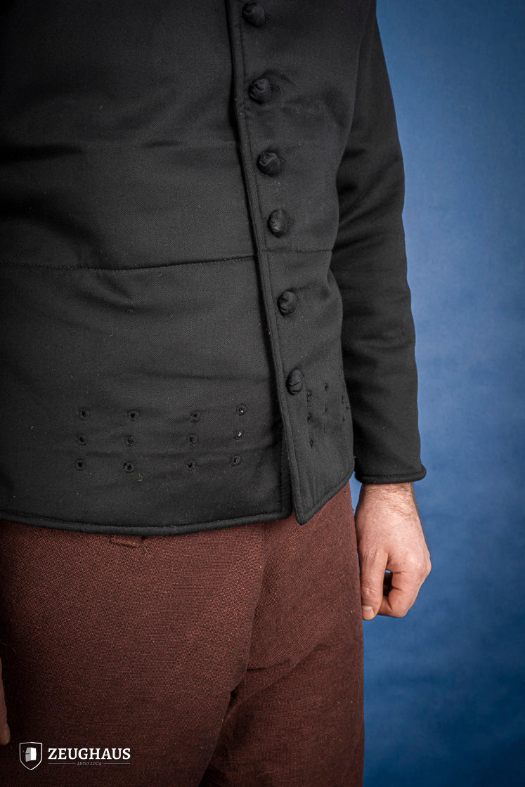 A black 15th-century style arming doublet made of cotton, featuring reinforced armholes and polyester-wool padding, ideal for historical reenactments.