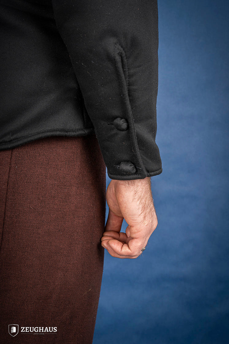 A black 15th-century style arming doublet made of cotton, featuring reinforced armholes and polyester-wool padding, ideal for historical reenactments.