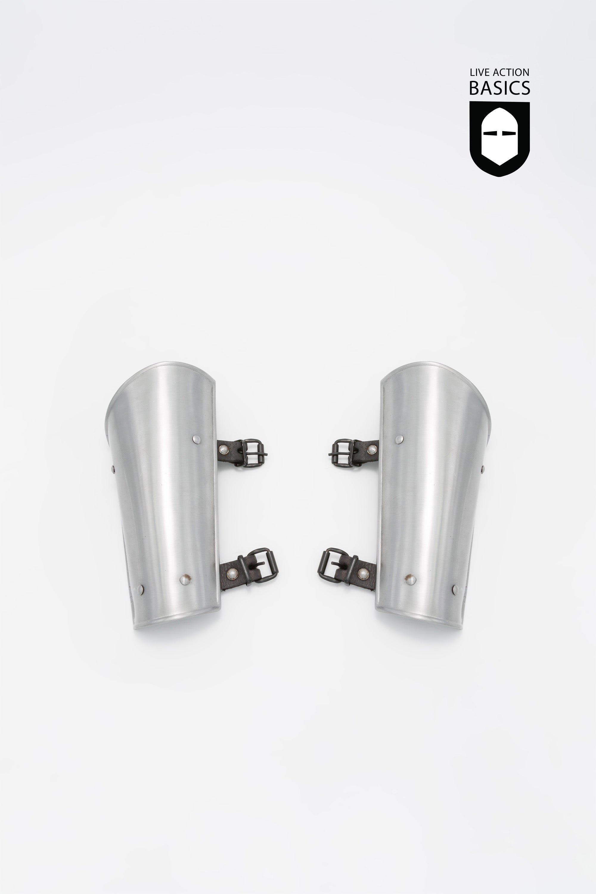 A pair of Basic Bracers made from mild steel, featuring adjustable straps for a secure fit, designed for arm and wrist protection.