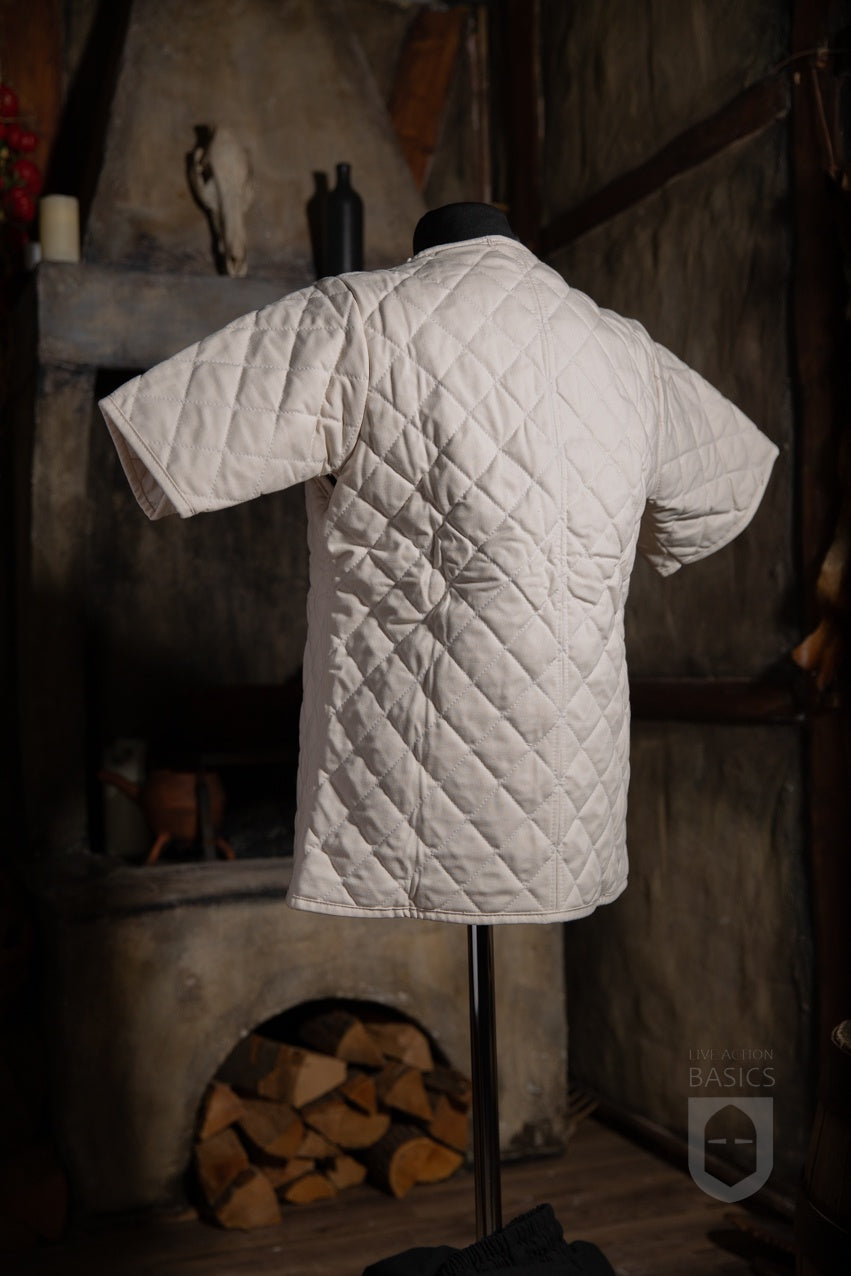 Basic Gambeson Natural made of heavy cotton canvas with a quilted diamond design and ribbons for fastening.