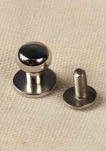 Five button rivets made of brass and iron, showcasing various finishes including raw brass and nickel.