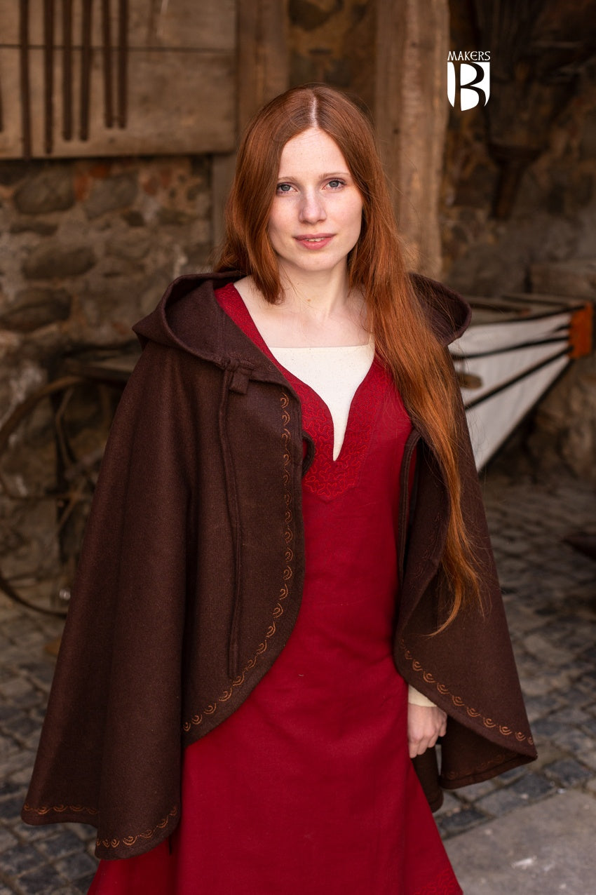 A stylish brown wool felt cape with a pointed hood and ornamental embroidery, designed for warmth and elegance.