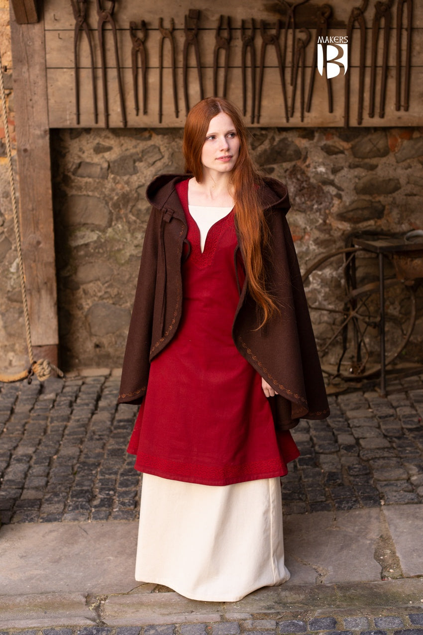 A stylish brown wool felt cape with a pointed hood and ornamental embroidery, designed for warmth and elegance.