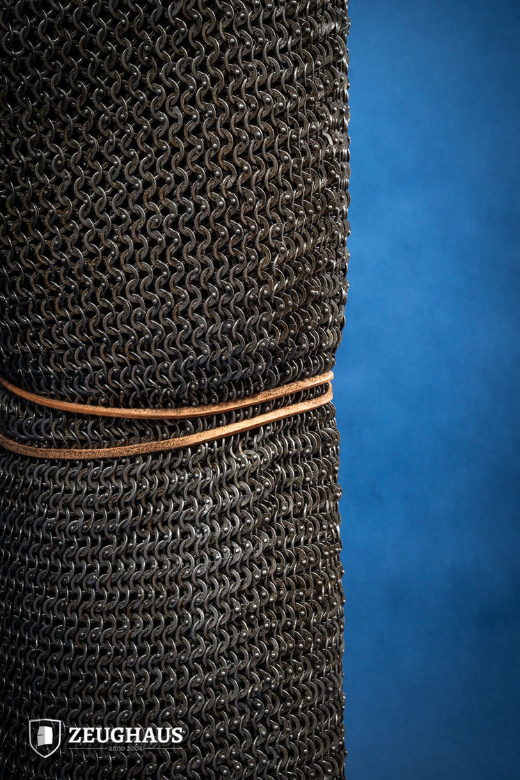 Chainmail Chausses made of 6mm oiled mild steel with flat riveted rings, showcasing intricate craftsmanship and historical design.