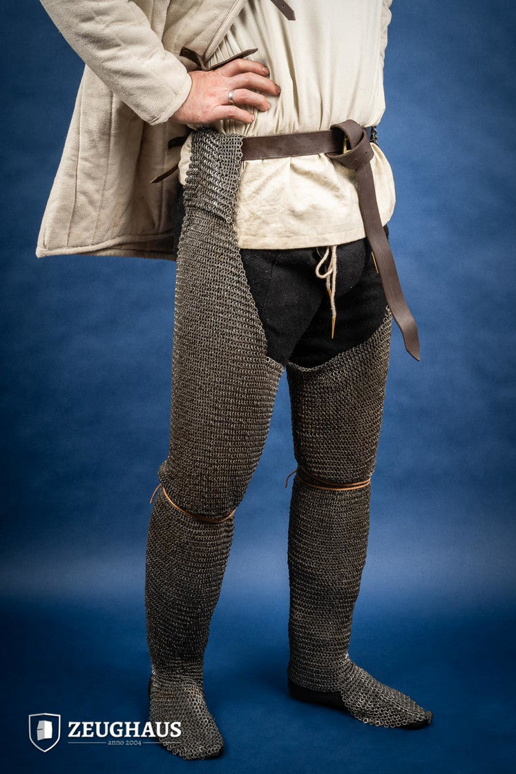 Chainmail Chausses made of 6mm oiled mild steel with flat riveted rings, showcasing intricate craftsmanship and historical design.