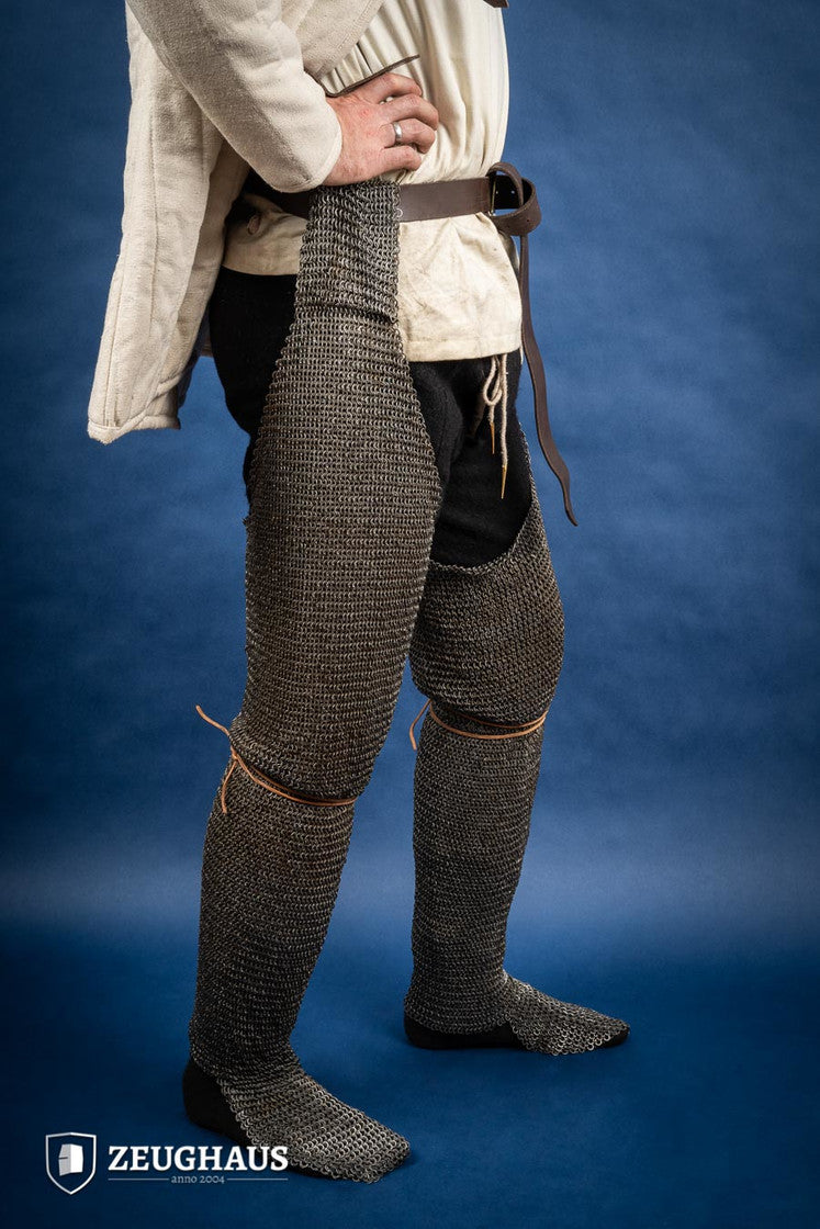 Chainmail Chausses made of 6mm oiled mild steel with flat riveted rings, showcasing intricate craftsmanship and historical design.