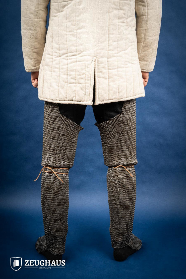 Chainmail Chausses made of 6mm oiled mild steel with flat riveted rings, showcasing intricate craftsmanship and historical design.