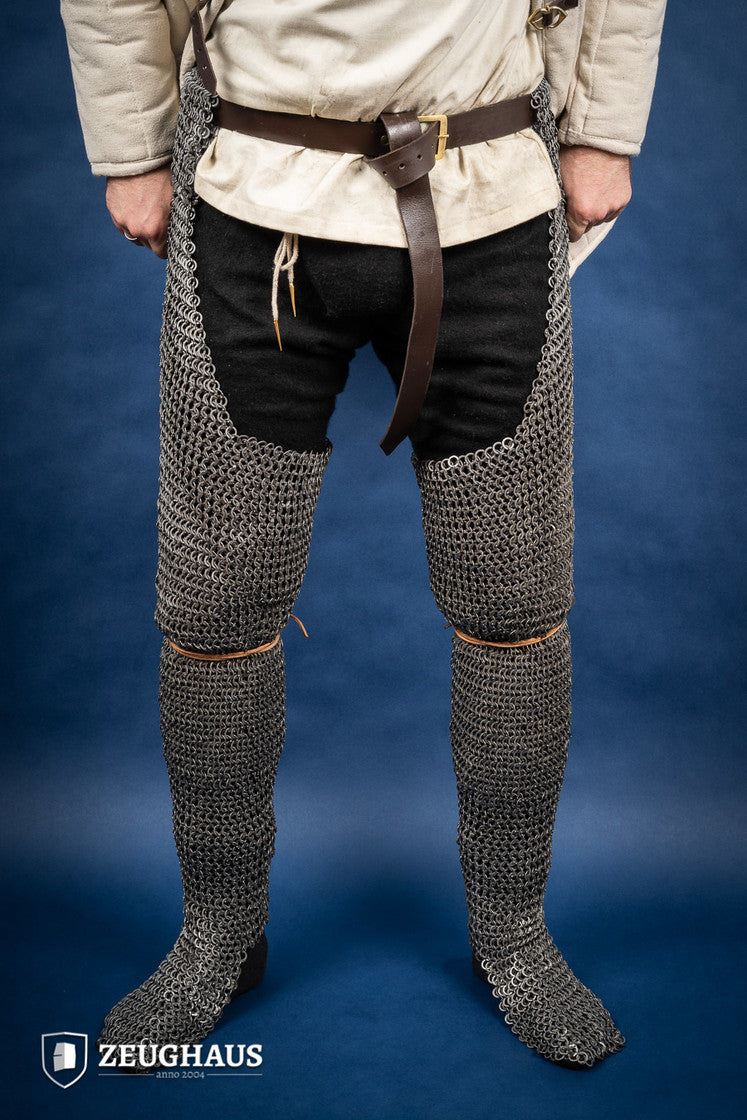 Chainmail chausses made of 9mm oiled mild steel, featuring flat rings and riveted construction, ideal for historical reenactments.
