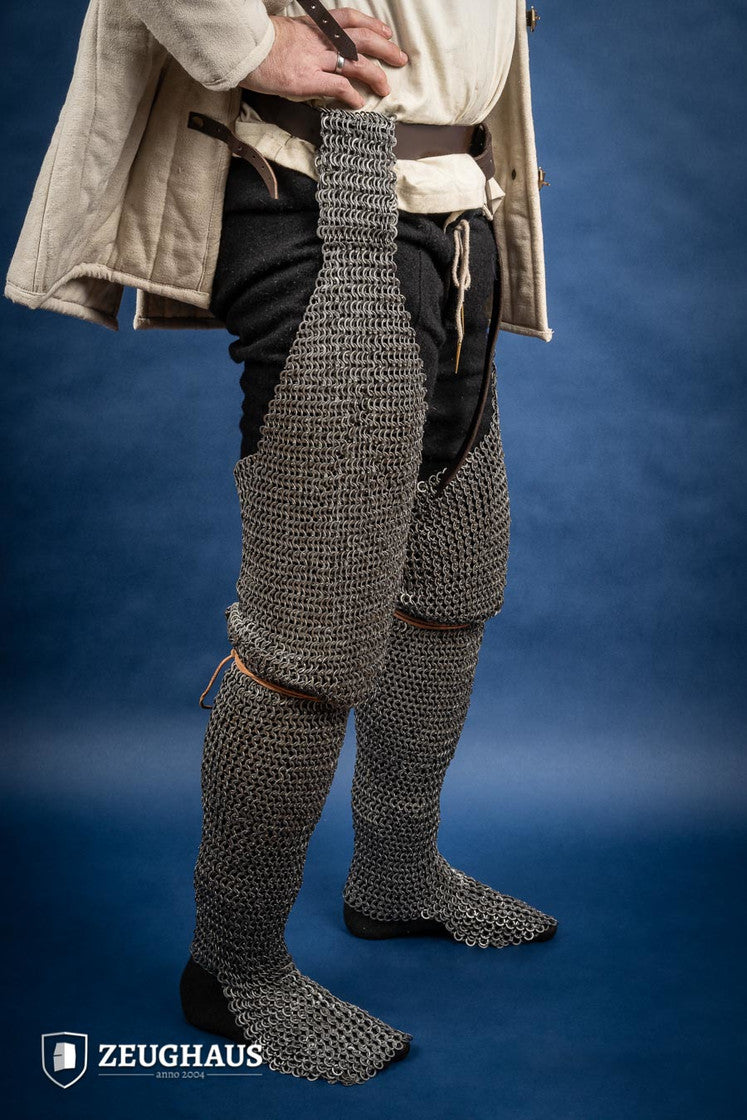Chainmail chausses made of 9mm oiled mild steel, featuring flat rings and riveted construction, ideal for historical reenactments.