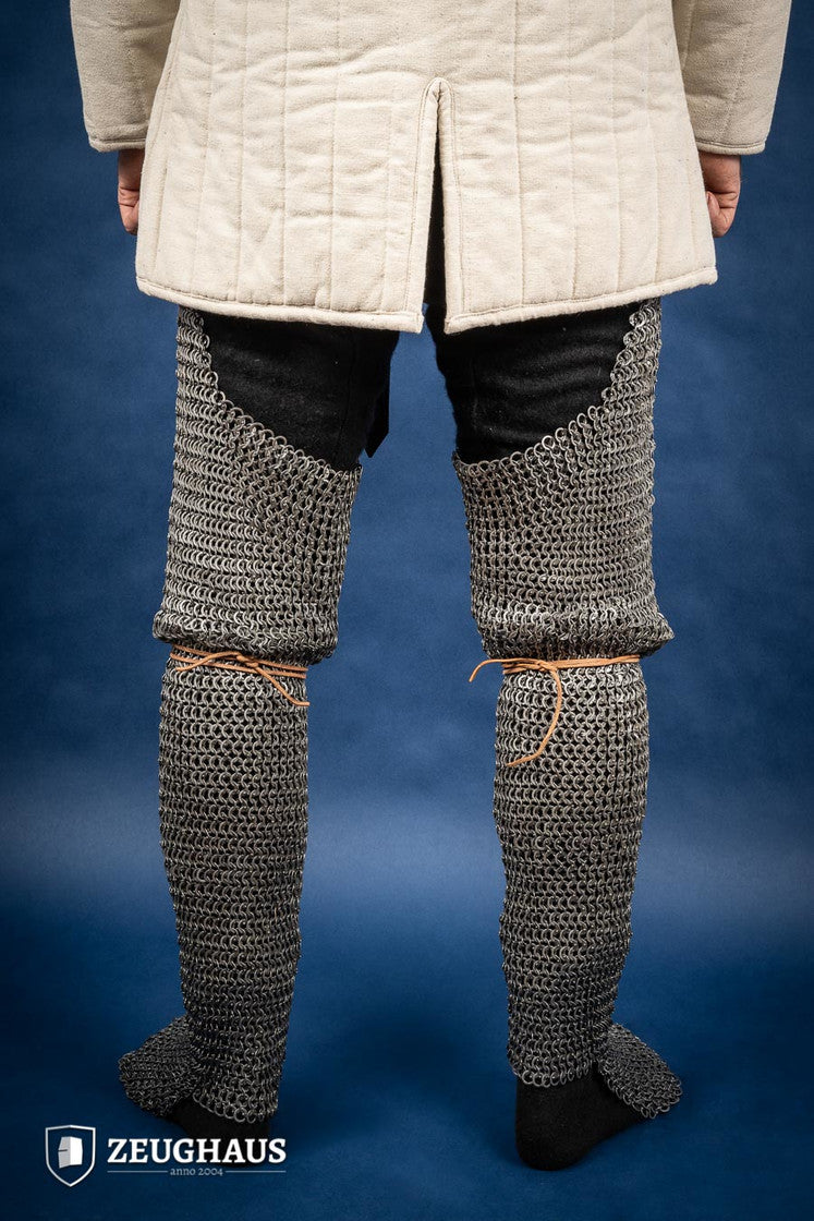 Chainmail chausses made of 9mm oiled mild steel, featuring flat rings and riveted construction, ideal for historical reenactments.