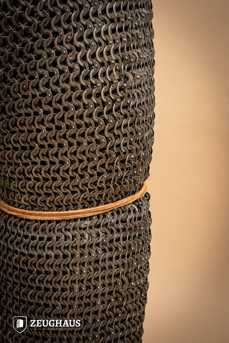 Chainmail Chausses made of oiled mild steel with flat rings, showcasing riveted construction and European 4-in-1 braid type.