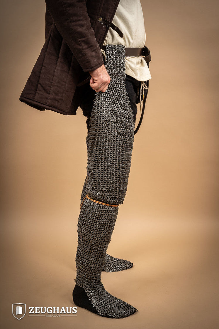 Chainmail Chausses made of oiled mild steel with flat rings, showcasing riveted construction and European 4-in-1 braid type.
