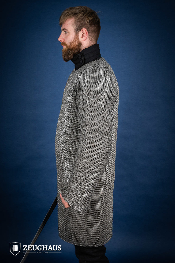 Chainmail Hauberk made of 6mm oiled mild steel with flat rings, showcasing its intricate riveted design and European 4-in-1 braid style.