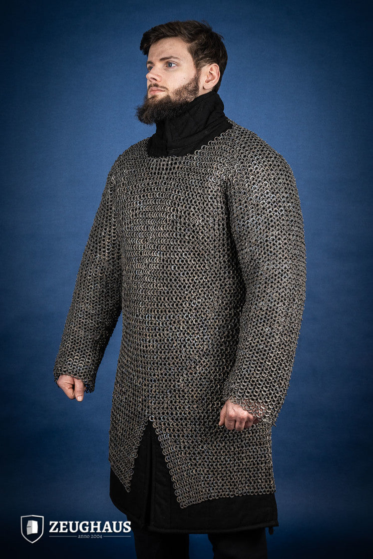 A detailed view of the Chainmail Hauberk Flatring Riveted 9mm Titanium, showcasing its long sleeves, split design, and riveted flat rings for enhanced protection.
