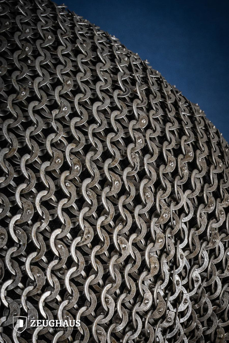 Chainmail Hauberk made of 9mm steel with wedge riveted design, featuring a natural oiled finish, showcasing its durability and classic European style.