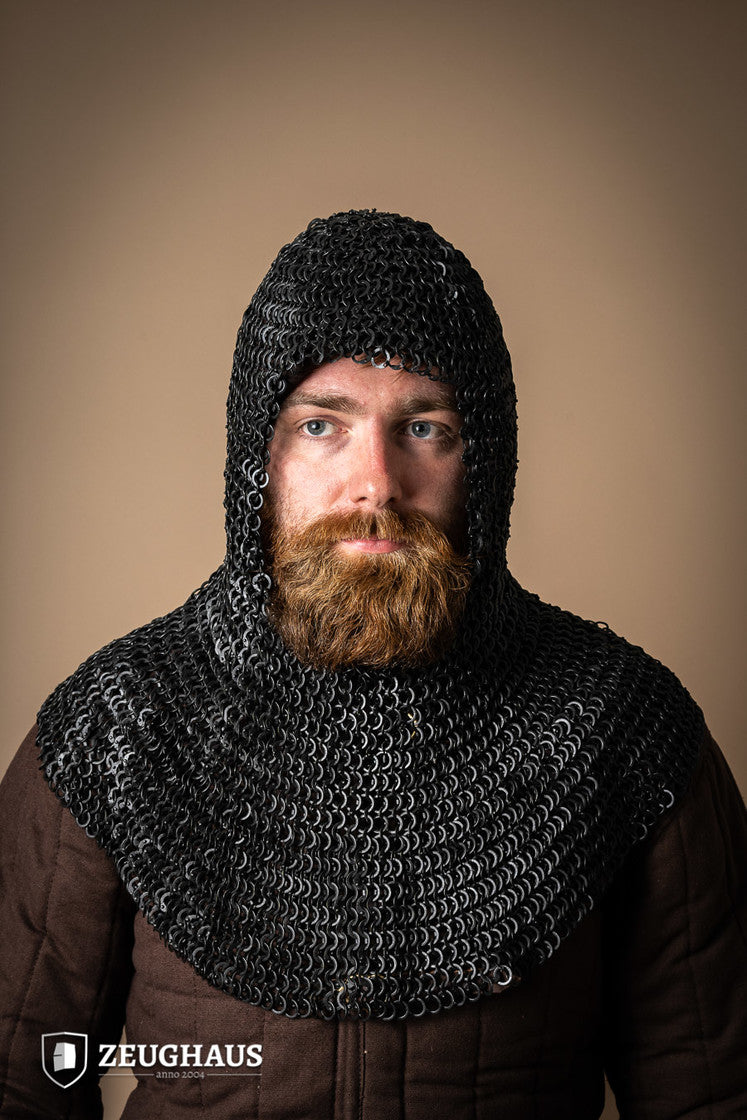 A detailed view of a burnished chainmail hood made from mild steel, featuring flat rings and a unique riveting pattern.