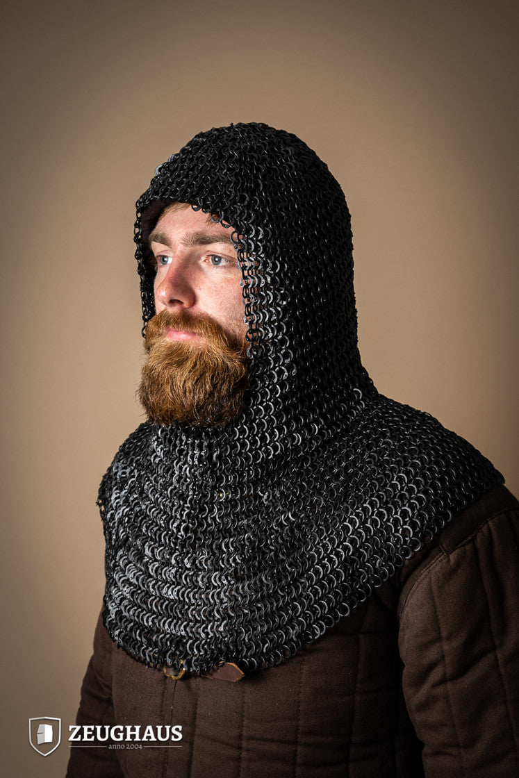 A detailed view of a burnished chainmail hood made from mild steel, featuring flat rings and a unique riveting pattern.