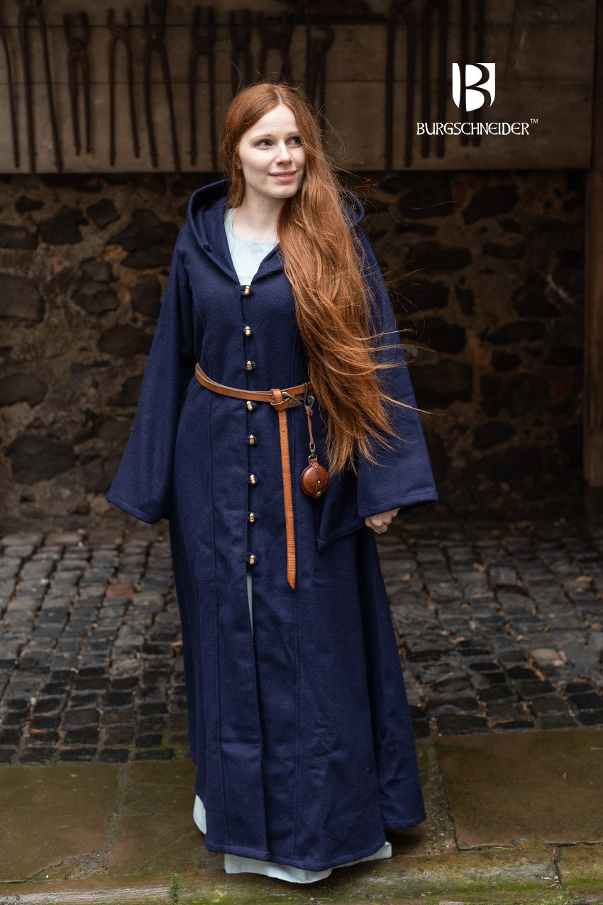 Tuala Blue Coat made of warm wool felt with solid brass buttons, featuring a large hood and flared sleeves.