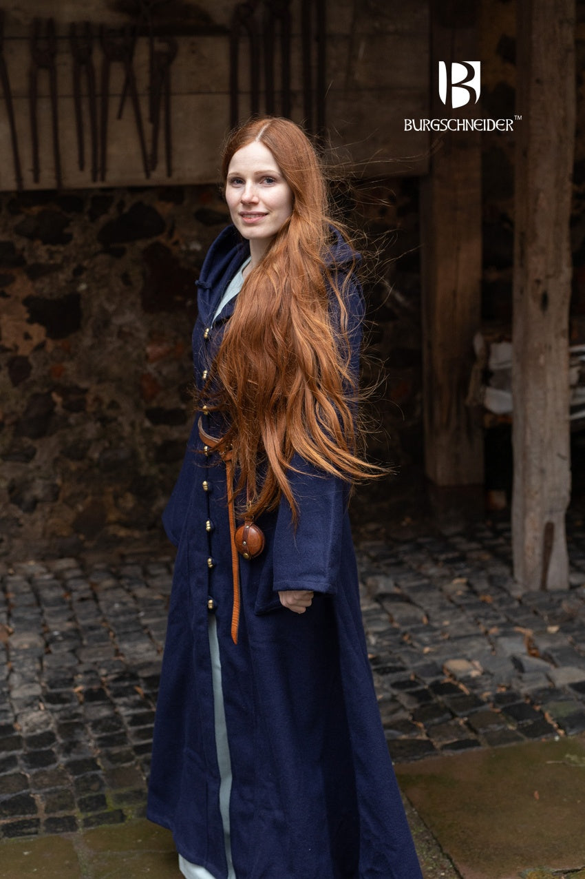 Tuala Blue Coat made of warm wool felt with solid brass buttons, featuring a large hood and flared sleeves.