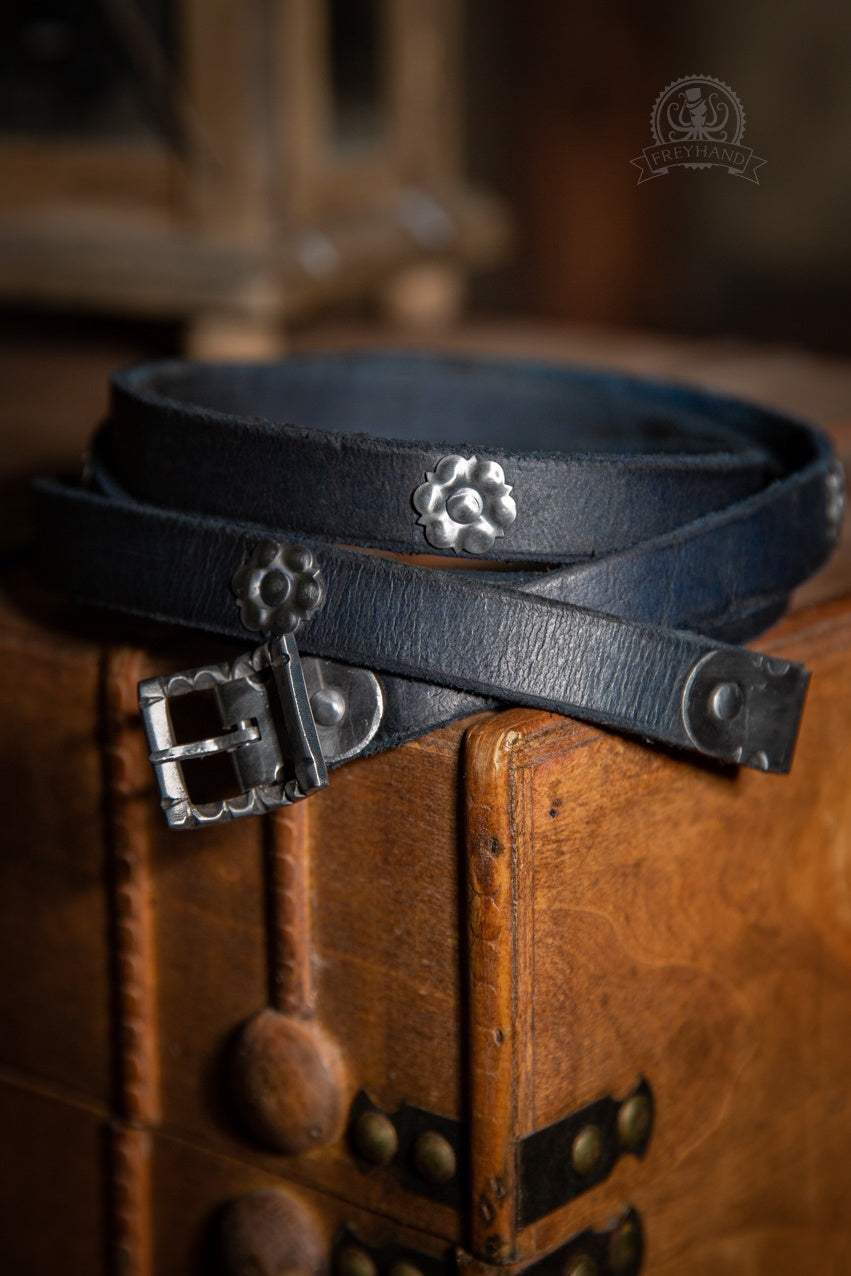 Decorated Belt Wolfram Blue with metal adornments and silver buckle, showcasing its elegant design and rich color.