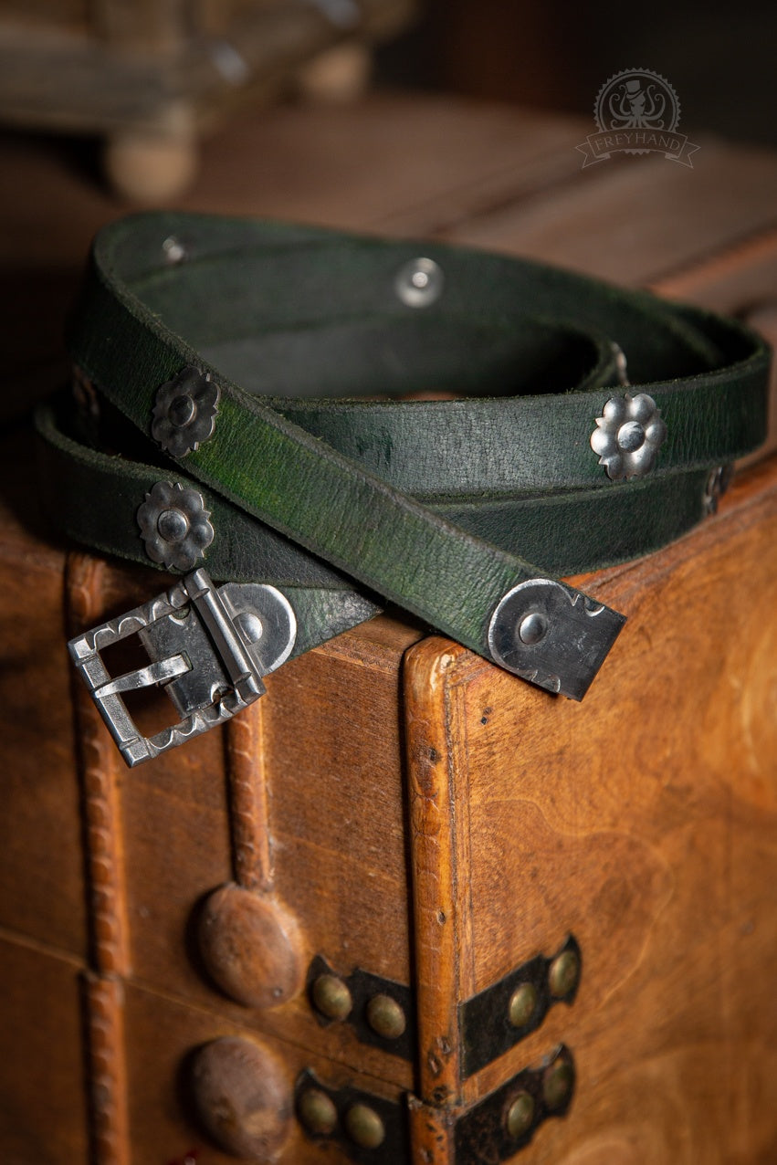 Decorated Belt Wolfram Green with metal adornments and silver buckle, showcasing its elegant design.
