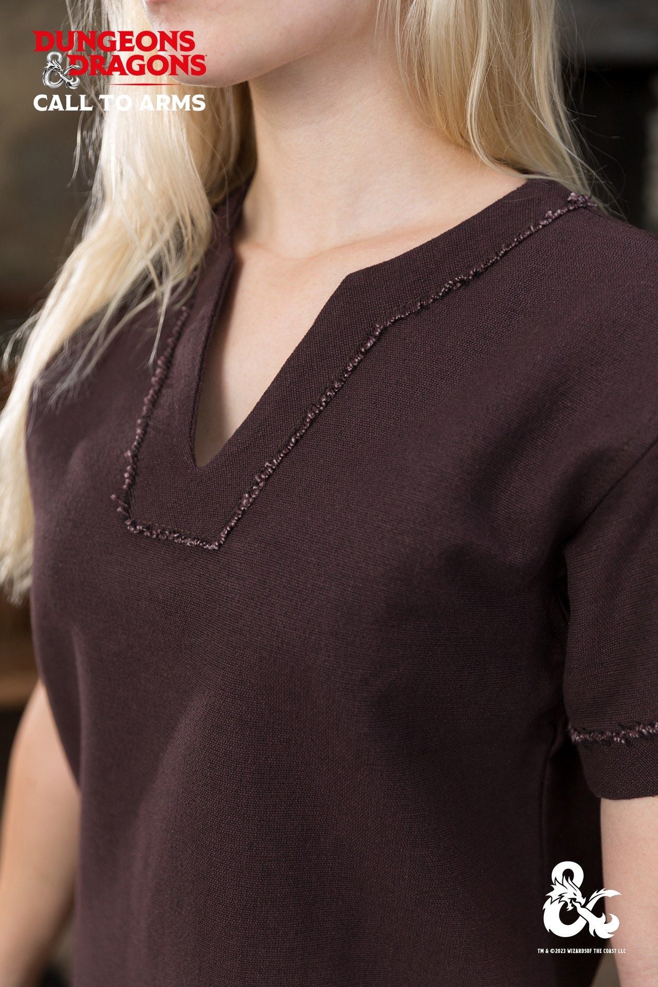 Brown Dungeons & Dragons Barbarian Shirt with short sleeves and V-neck, featuring unique bias cut trim and frayed edges.