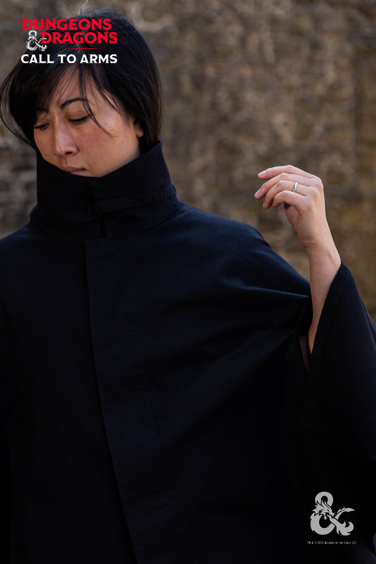 Dungeons & Dragons Rogue Cape in black, featuring a turn-over collar, drawstrings for a hood, and a hidden button pocket.