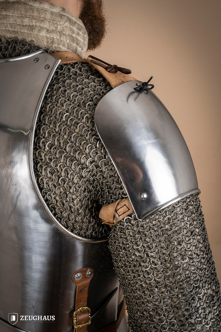 Early 15th Century Pauldrons made from 2.5mm polished steel, featuring a unique raised groove for enhanced mobility and protection.