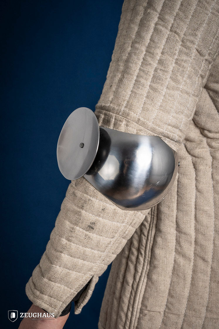 Polished 1.6mm steel elbow caps showcasing craftsmanship and durability.