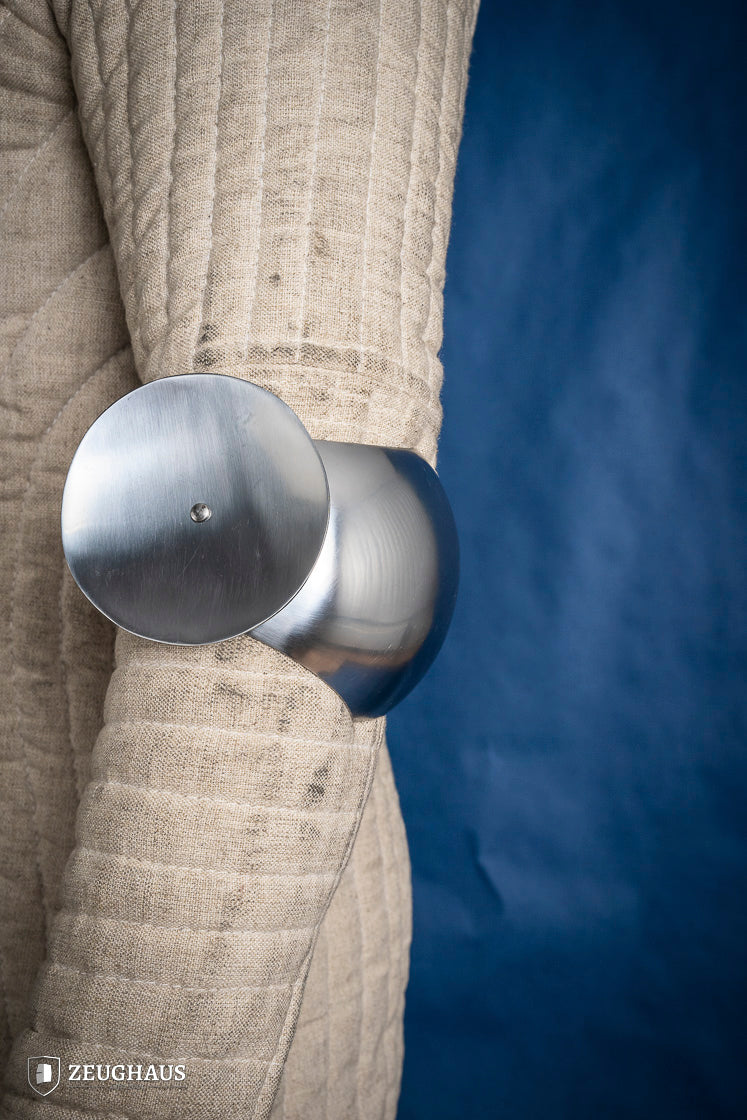 Polished 1.6mm steel elbow caps showcasing craftsmanship and durability.