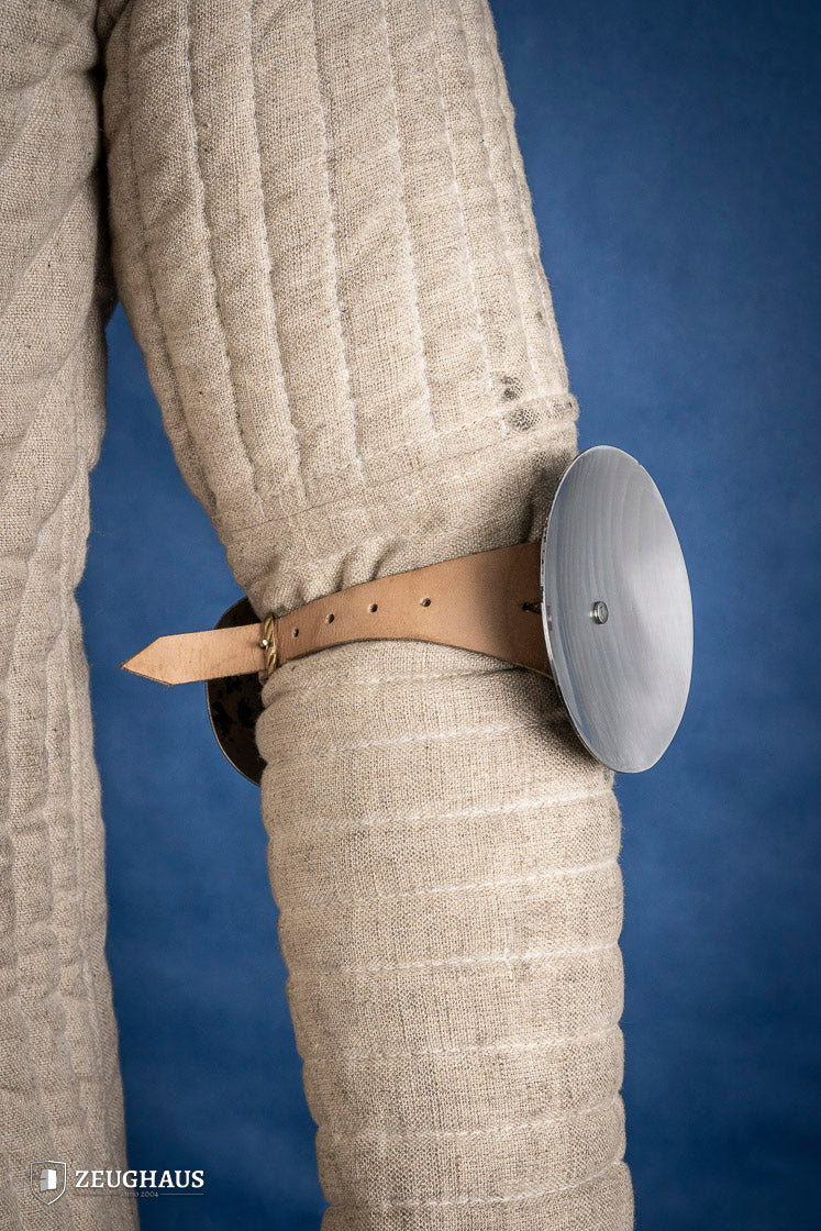 Polished 1.6mm steel elbow caps showcasing craftsmanship and durability.