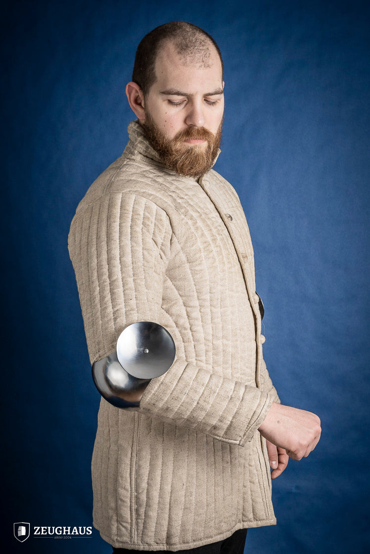 Polished 1.6mm steel elbow caps showcasing craftsmanship and durability.