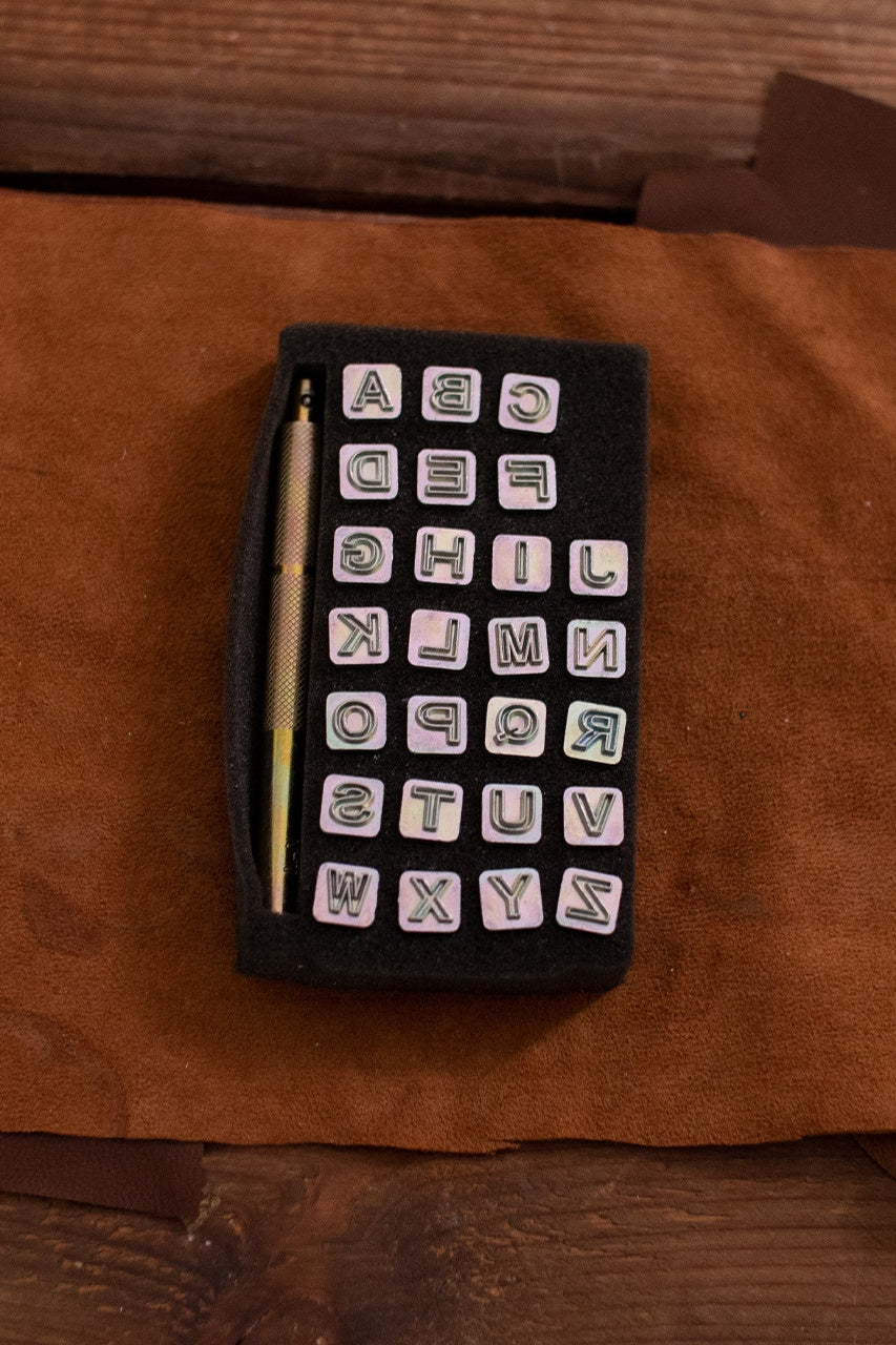 Embossing Tool Set Alphabet BLOCK featuring 26 iron stamps and 1 iron handle, ideal for personalizing leather projects.