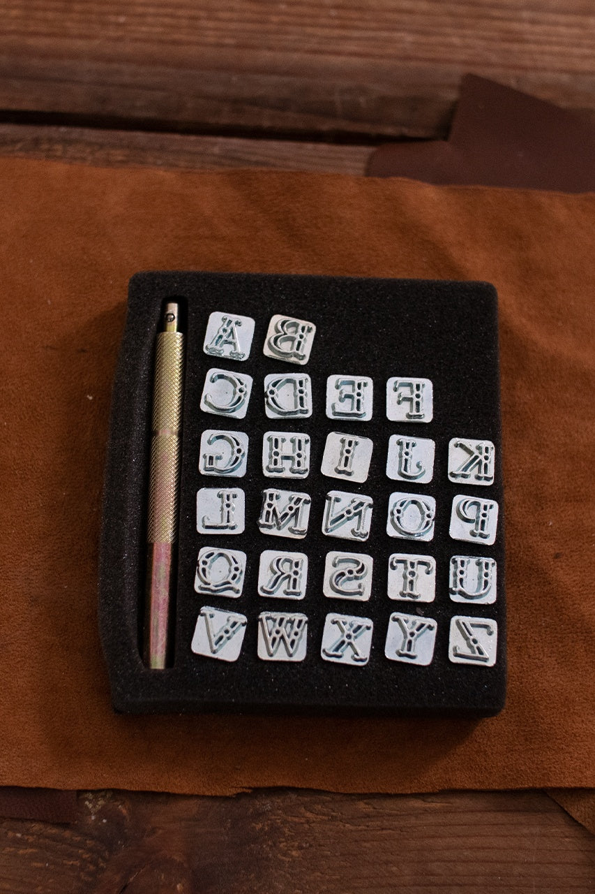 Embossing Tool Set Alphabet CASTELL featuring 26 iron stamps and a handle, ideal for personalizing leather projects.