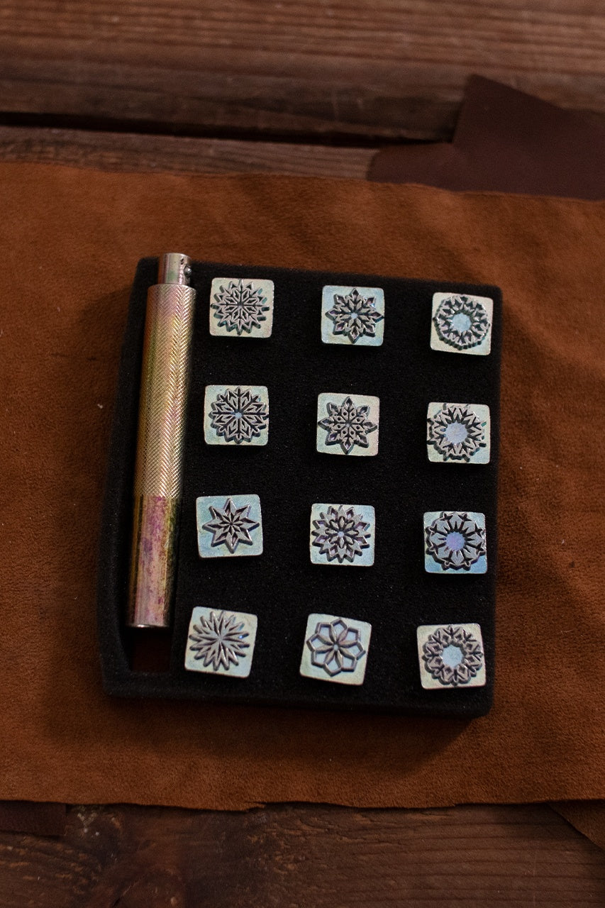 Embossing Tool Set featuring 12 iron stamps and 1 iron handle for geometric designs on leather.