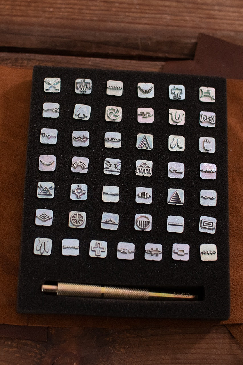 Embossing Tool Set with Native American symbols, featuring 42 stamps and an ergonomic handle for leather crafting.