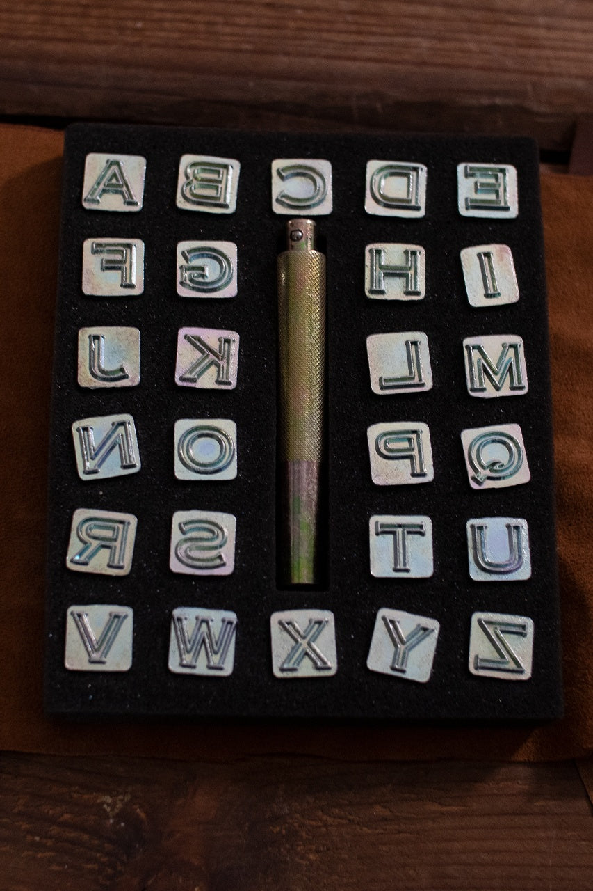 Embossing Tool Set featuring 26 iron stamps and a handle, designed for personalizing leather projects with numbers.