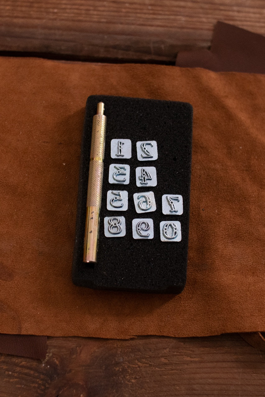 Embossing Tool Set CASTELL featuring 10 iron number stamps and an iron handle, ideal for personalizing leather projects.