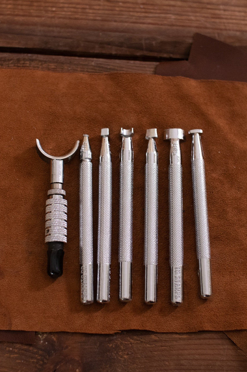 Embossing Tool Set featuring 7 iron tools including a swivel knife, designed for leather crafting.