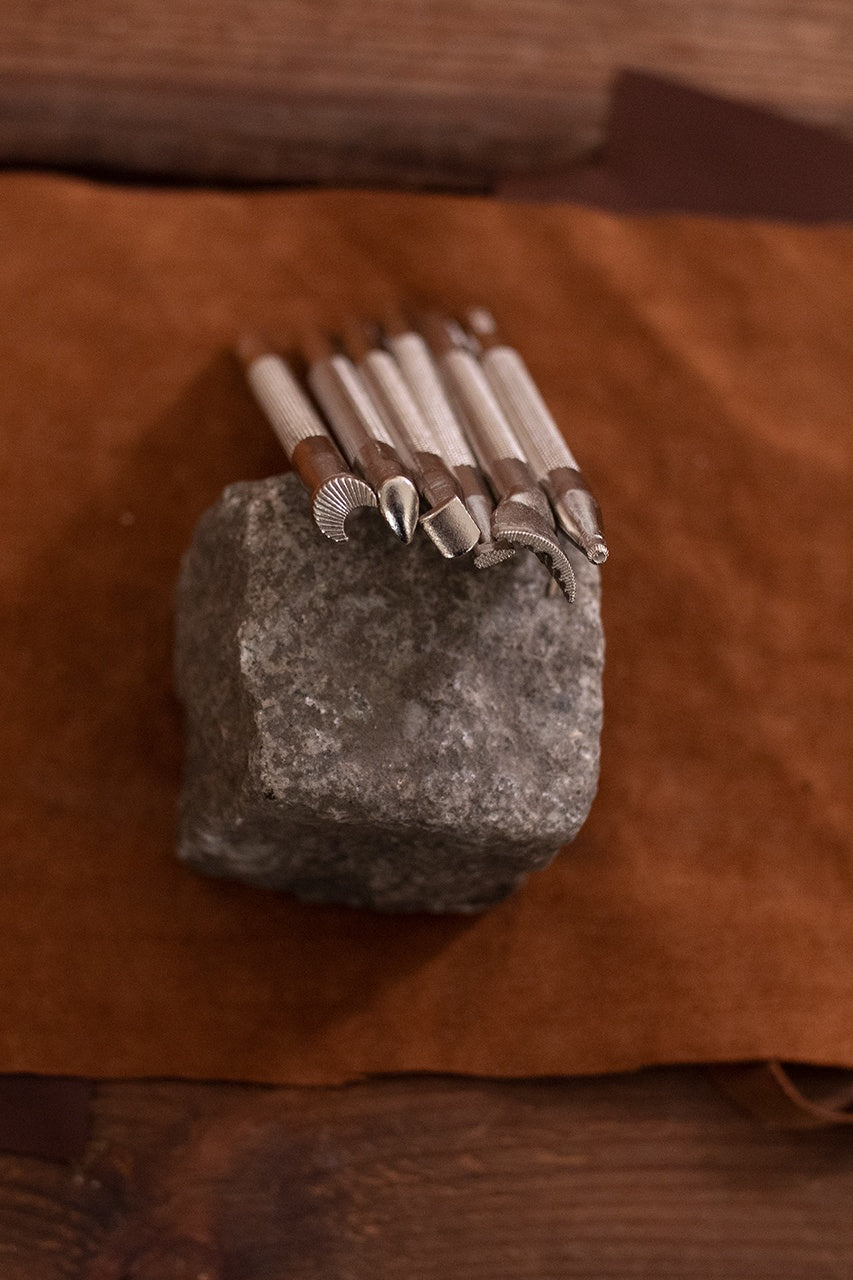 Embossing Tool Set featuring six iron tools for leather crafting, showcasing their ergonomic design and durability.