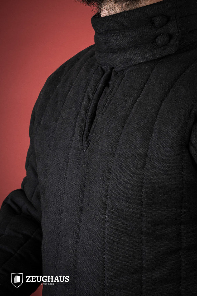 A detailed view of the 13th Century Black Gambeson featuring a stand-up collar and seamless construction, perfect for historical reenactments.