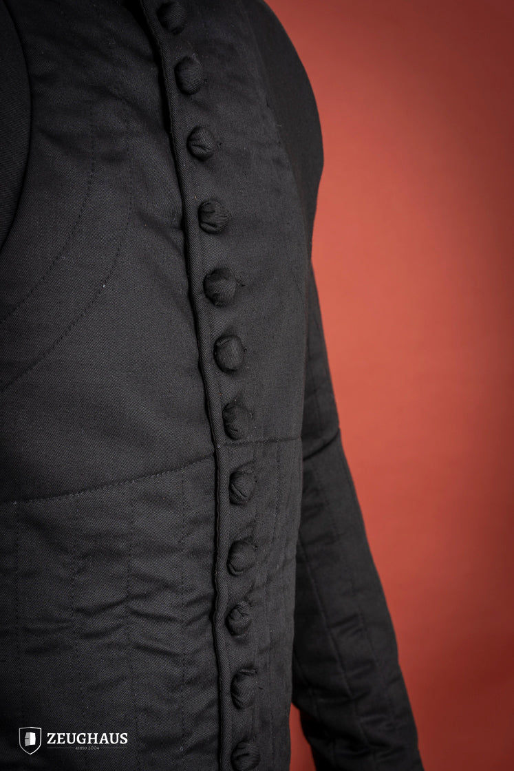 14th Century Black Gambeson featuring 100% cotton fabric and polyester padding, designed for mobility and protection.