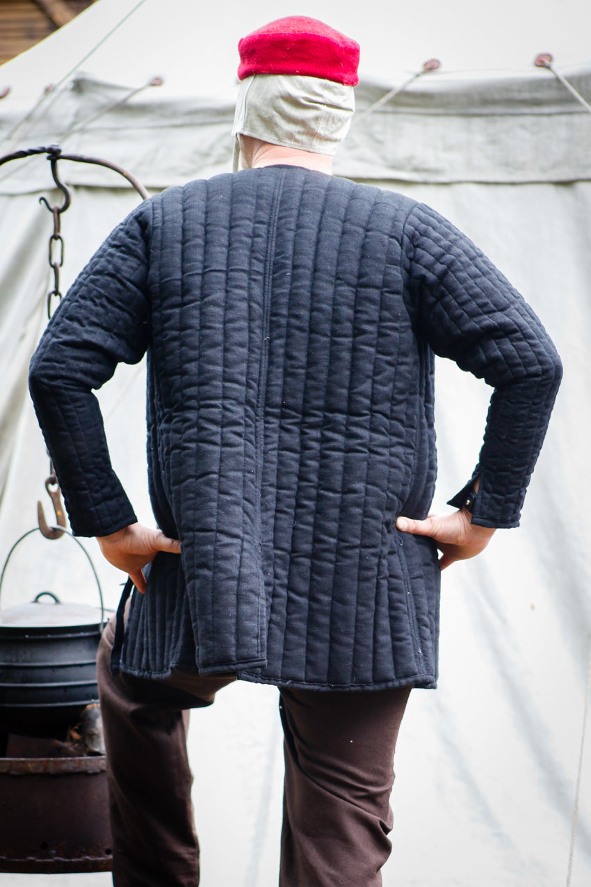 Gambeson Sturmeck Black, a thigh-length protective garment with long sleeves, featuring lacing fasteners and made from cotton canvas.