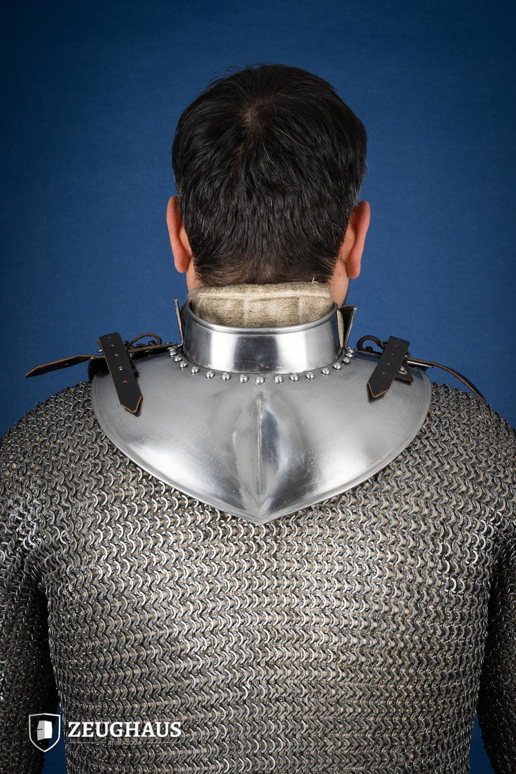 Polished gorget with stand-up collar, featuring crimped edges and leather straps, designed for neck protection and flexibility.